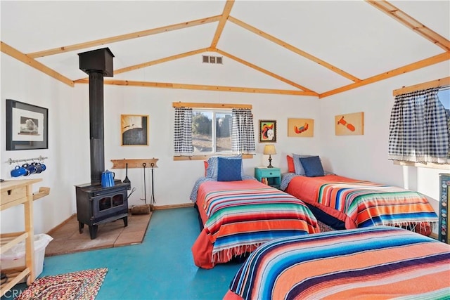 bedroom featuring vaulted ceiling, a wood stove, and carpet flooring