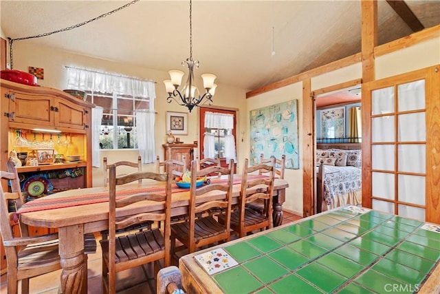 dining space featuring lofted ceiling and a chandelier