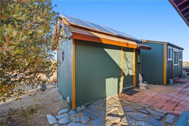 view of outdoor structure featuring solar panels