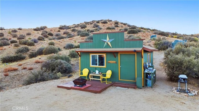 view of outdoor structure featuring a fire pit