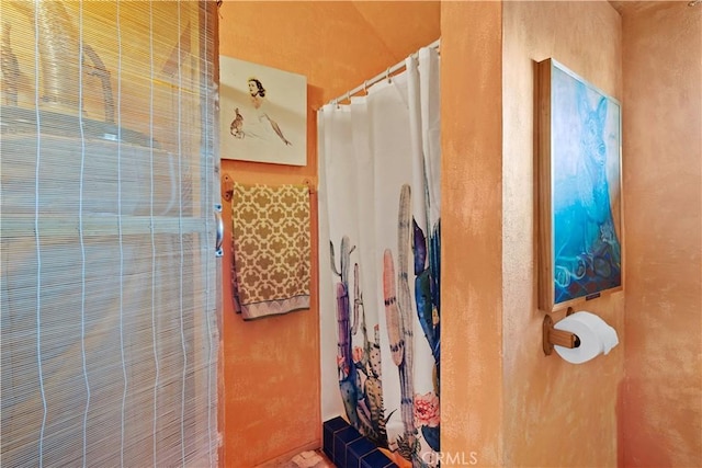 bathroom with a shower with shower curtain