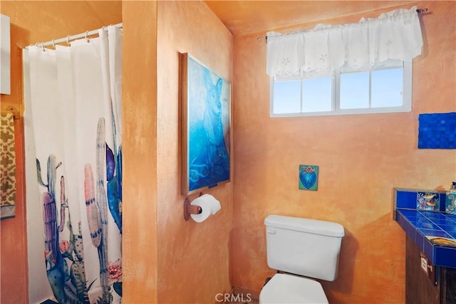 bathroom with toilet and walk in shower