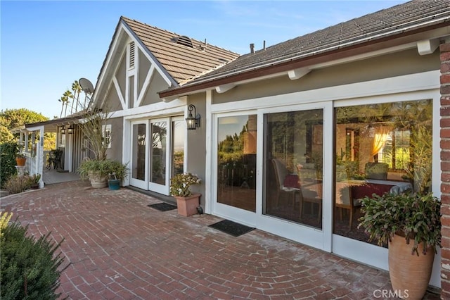 back of property with a patio area and french doors