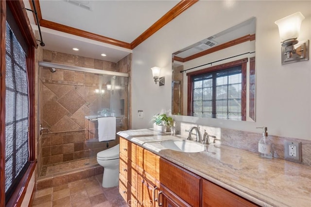 bathroom featuring toilet, vanity, crown molding, and walk in shower