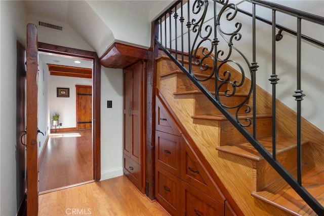 stairs featuring wood-type flooring