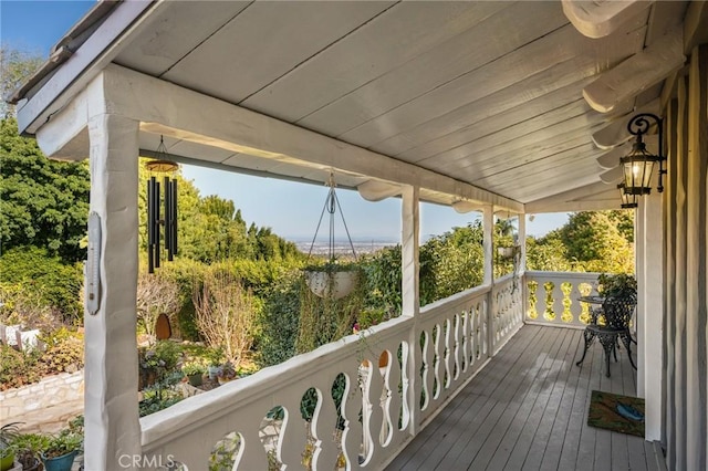 wooden terrace featuring covered porch