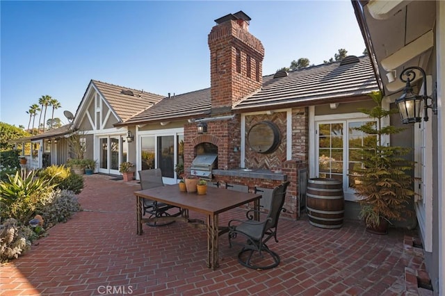 view of patio featuring a fireplace and grilling area