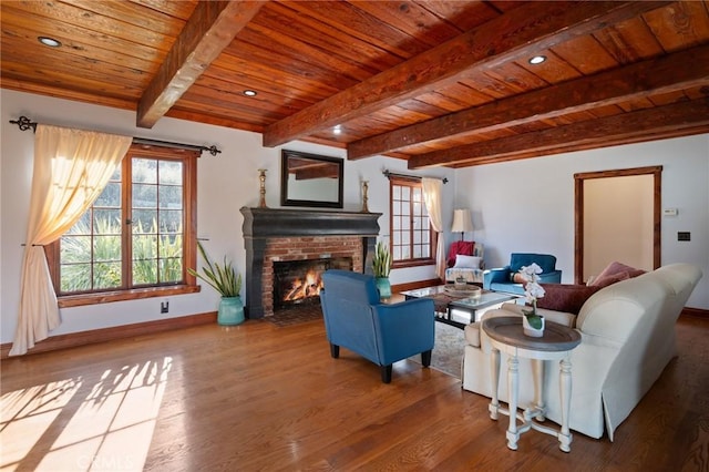 living room featuring a brick fireplace, beam ceiling, hardwood / wood-style floors, and wooden ceiling