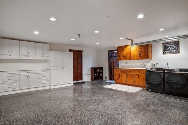 kitchen featuring sink, white cabinets, and independent washer and dryer