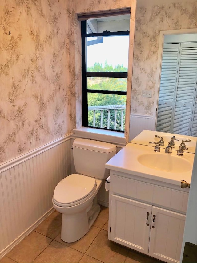 bathroom featuring vanity, toilet, and tile patterned flooring