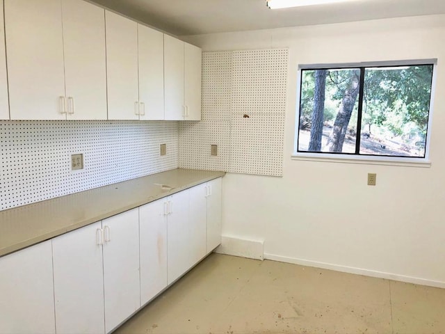 kitchen with white cabinetry and backsplash