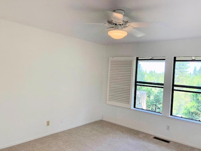 empty room with light colored carpet and ceiling fan