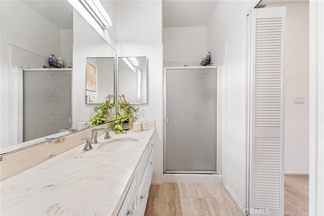 bathroom featuring walk in shower and vanity