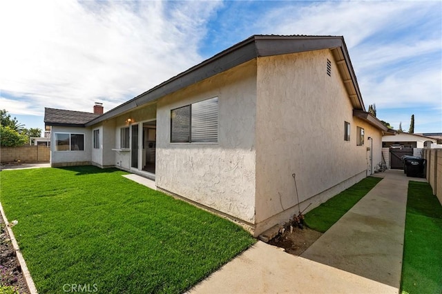 view of property exterior with a yard