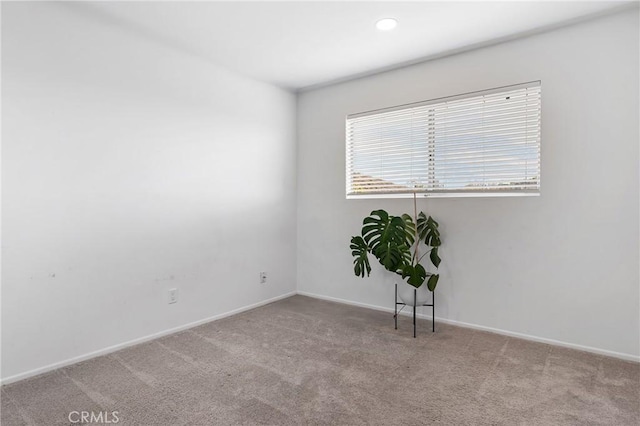 unfurnished room with light carpet