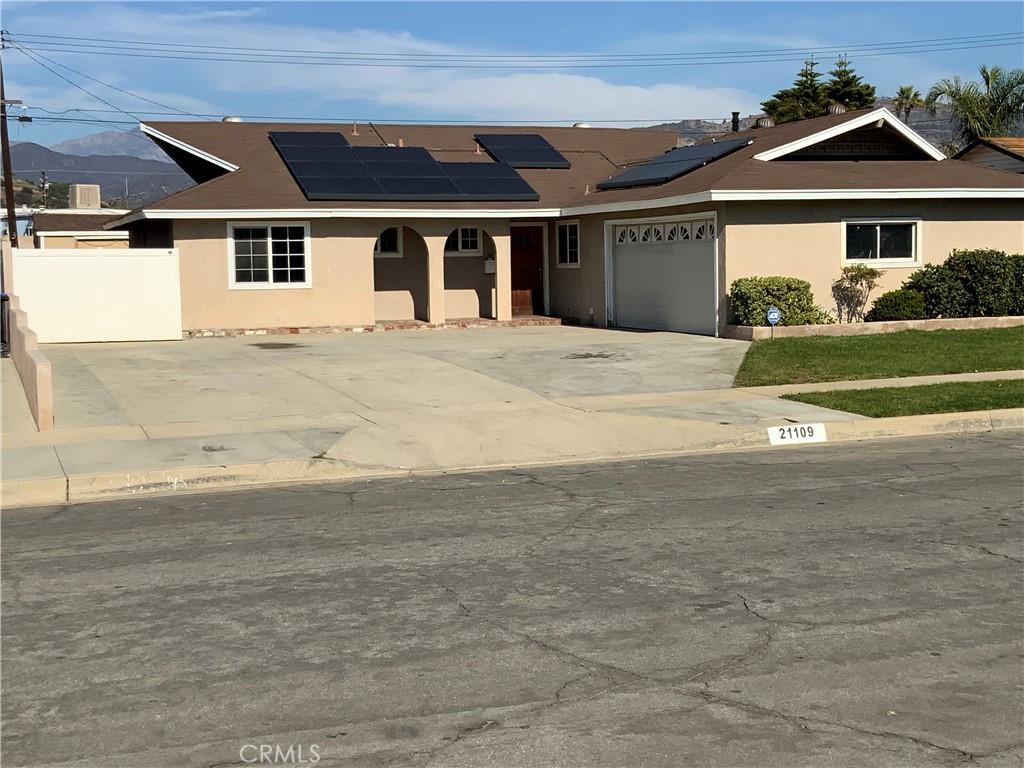 view of front of home featuring solar panels and a garage