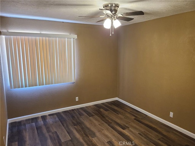 unfurnished room with ceiling fan, dark wood-type flooring, and a textured ceiling