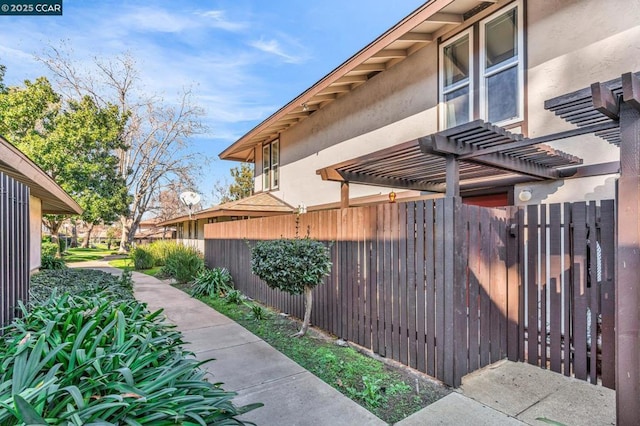 view of side of property featuring a pergola