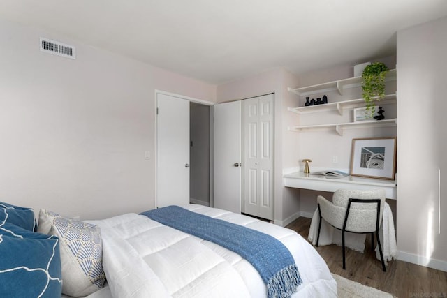 bedroom with hardwood / wood-style floors and a closet