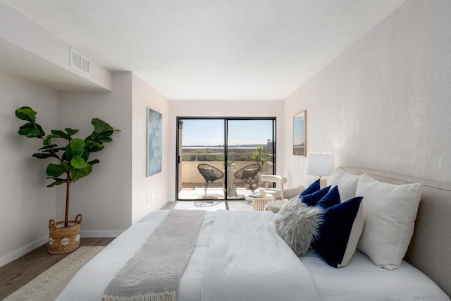 bedroom with light hardwood / wood-style flooring and access to outside