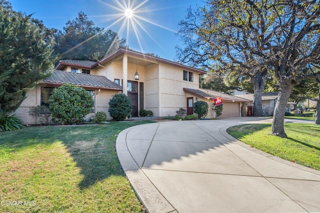 view of front facade with a front yard and a garage