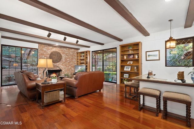 living room with a fireplace, wood-type flooring, and beamed ceiling