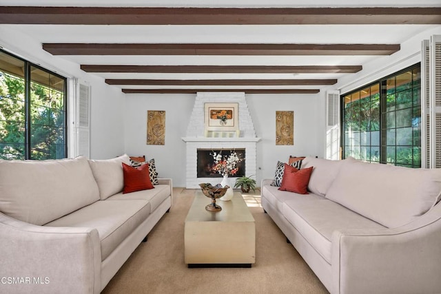 living room featuring light colored carpet, beam ceiling, and a fireplace