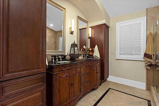 bathroom with tile patterned floors, vanity, and walk in shower