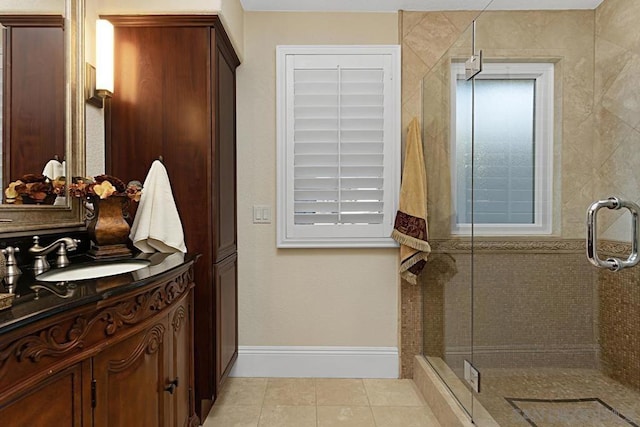 bathroom with tile patterned flooring, walk in shower, and vanity