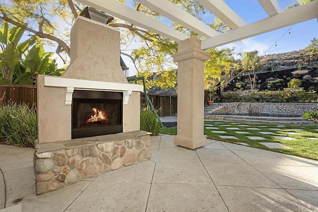 view of patio featuring exterior fireplace