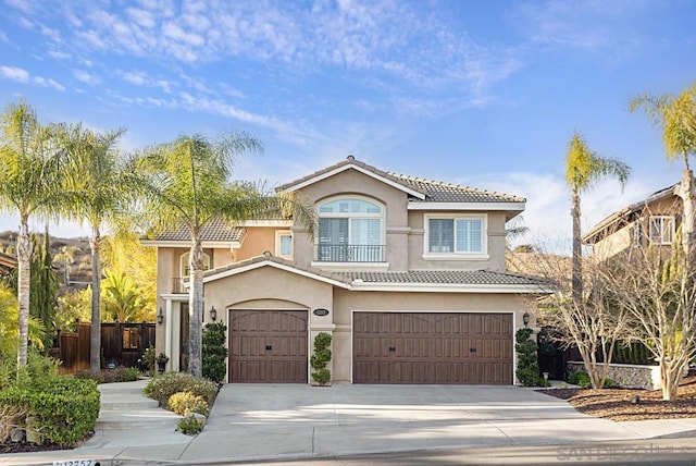 mediterranean / spanish-style house with a garage