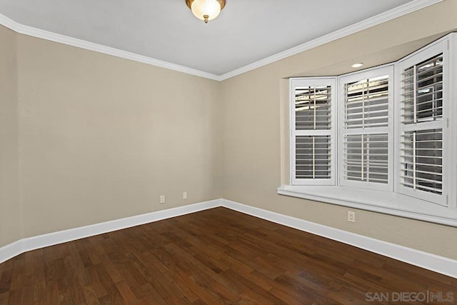 empty room featuring wood-type flooring and crown molding