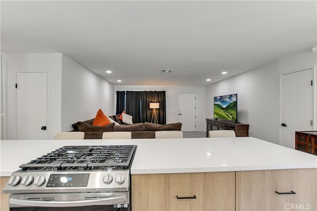 kitchen with light brown cabinets and gas range