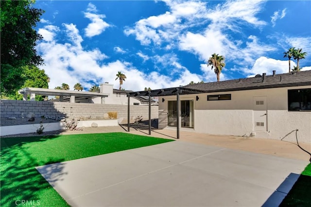 back of property with a yard, a patio, and a pergola