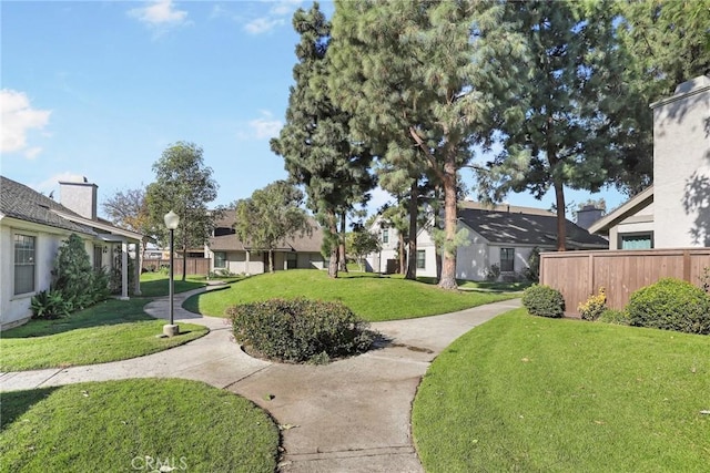 view of home's community with a yard