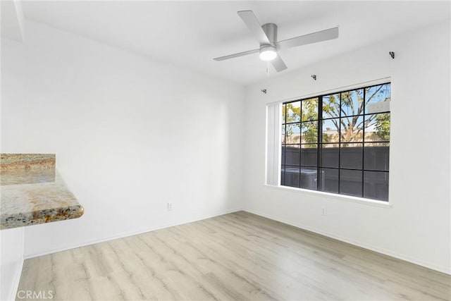 spare room with ceiling fan and light hardwood / wood-style floors