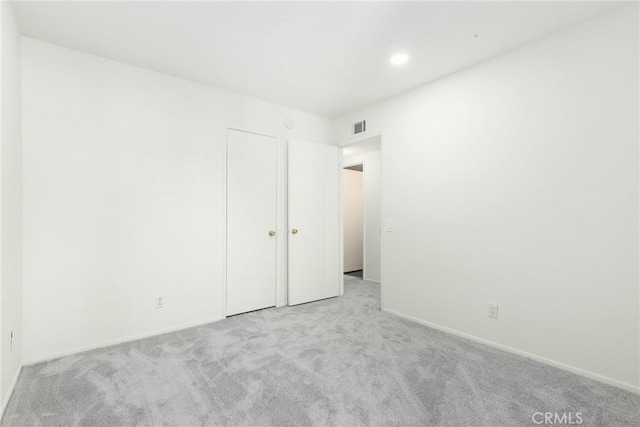 unfurnished room with light colored carpet