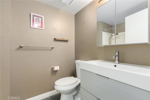 bathroom with toilet, vanity, walk in shower, and tile patterned flooring