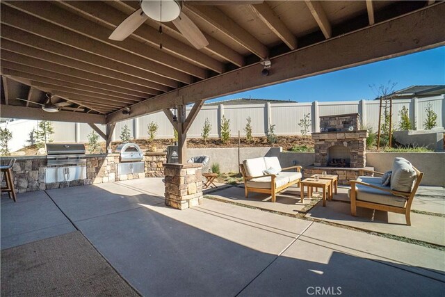 view of patio with ceiling fan, an outdoor living space with a fireplace, a grill, and area for grilling