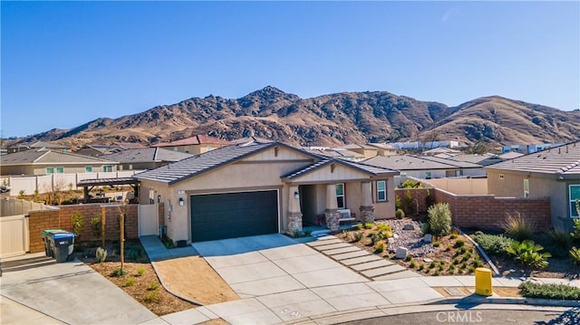 view of front of property featuring a garage and a mountain view