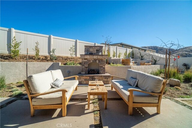 view of patio / terrace featuring an outdoor living space with a fireplace