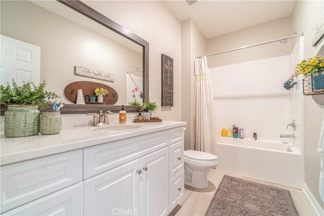 full bathroom featuring toilet, vanity, and shower / bath combo with shower curtain