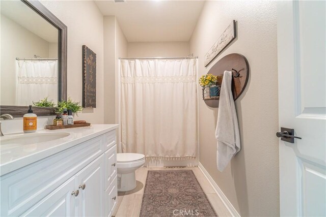 bathroom with toilet and vanity