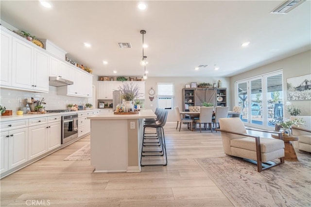 kitchen featuring white cabinets, appliances with stainless steel finishes, and a center island