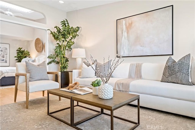 living room with ceiling fan and light hardwood / wood-style floors