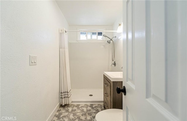 bathroom featuring vanity, toilet, and walk in shower