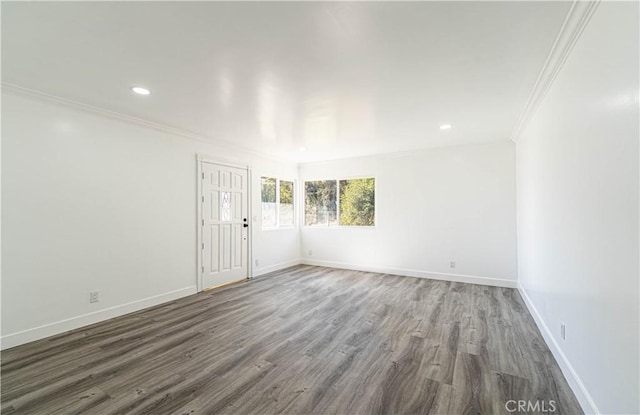 unfurnished room featuring dark hardwood / wood-style flooring and crown molding