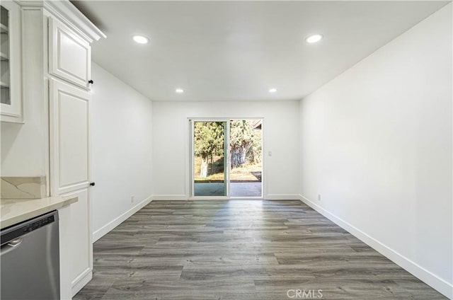 unfurnished dining area featuring dark wood-type flooring