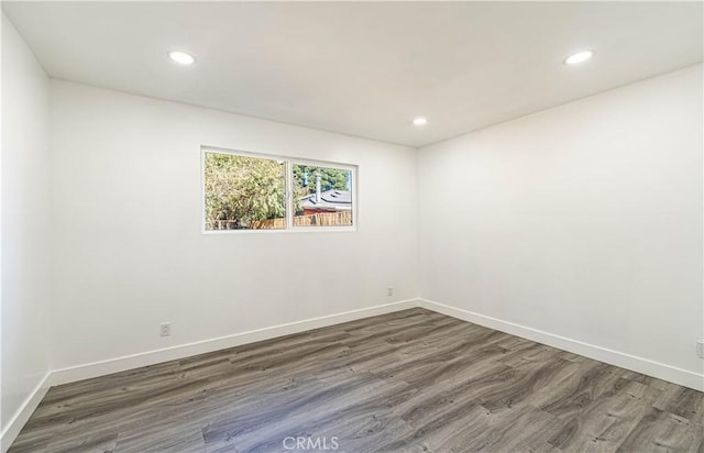 unfurnished room featuring dark hardwood / wood-style flooring