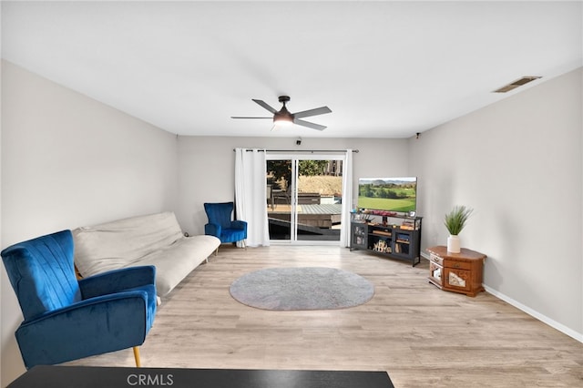 living room featuring ceiling fan and light hardwood / wood-style flooring